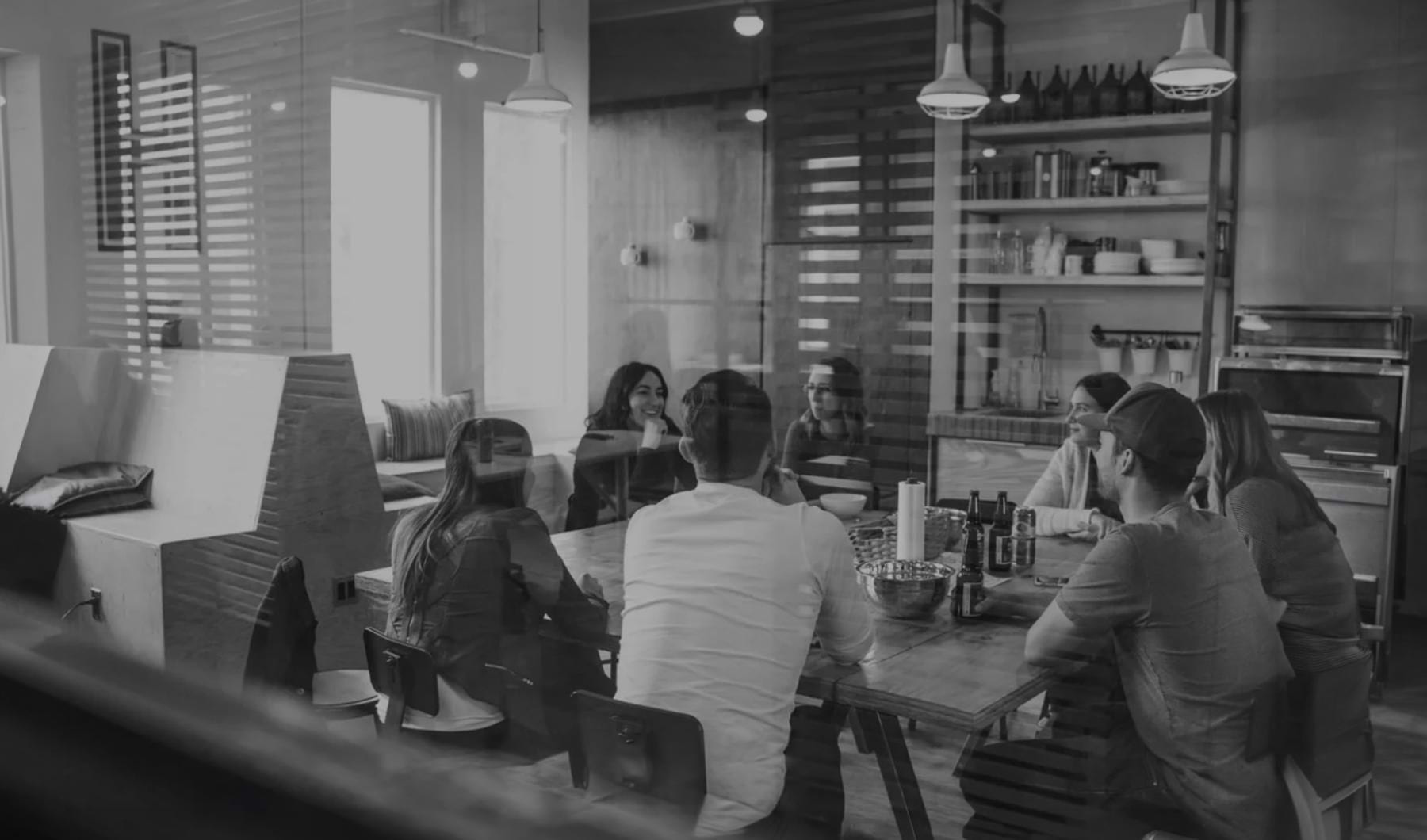 a group of people sitting at desks in a room
