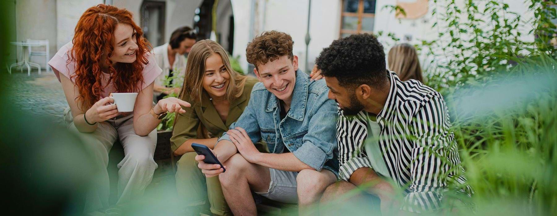 A group of people sitting at a table laughing with each other.